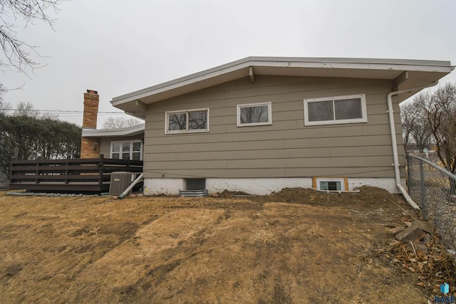 view of side of property featuring central AC