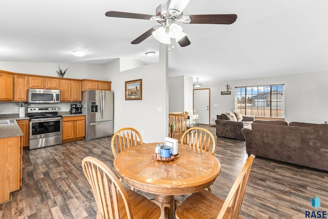 dining space with lofted ceiling, sink, dark hardwood / wood-style flooring, and ceiling fan