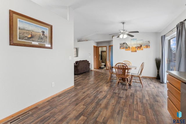 dining space with dark hardwood / wood-style flooring, vaulted ceiling, and ceiling fan