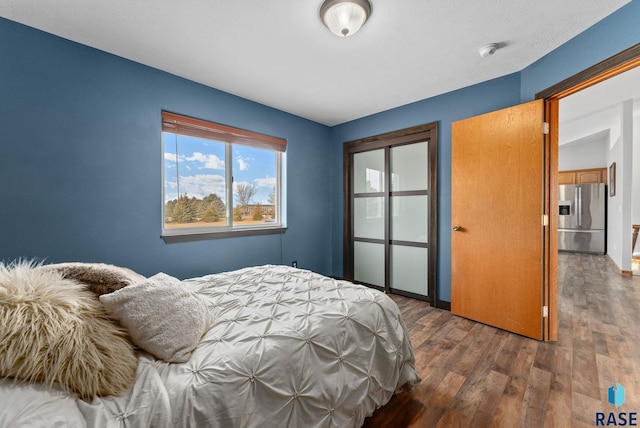 bedroom featuring stainless steel fridge with ice dispenser and dark hardwood / wood-style floors