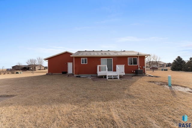 rear view of house with a yard and central air condition unit