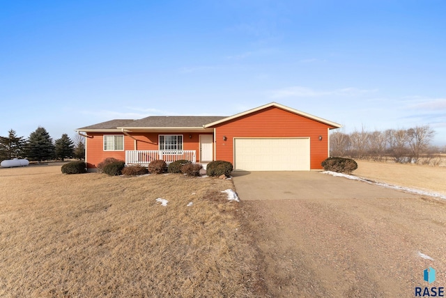 single story home featuring a garage, a front lawn, and a porch