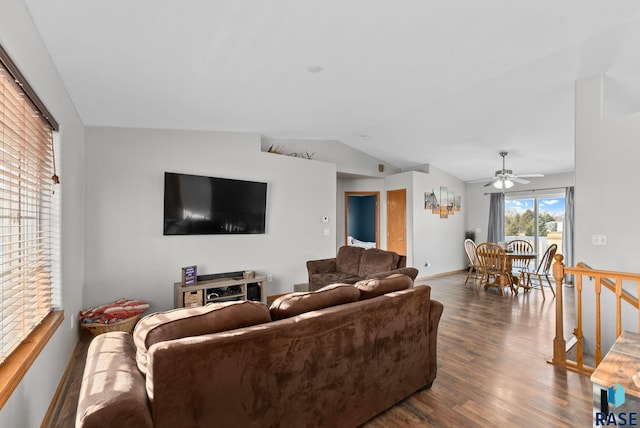 living room featuring vaulted ceiling, dark wood-type flooring, and ceiling fan