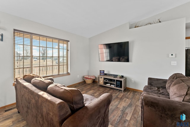 living room featuring dark hardwood / wood-style flooring and vaulted ceiling