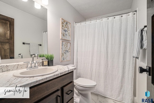 bathroom featuring vanity, toilet, and a textured ceiling