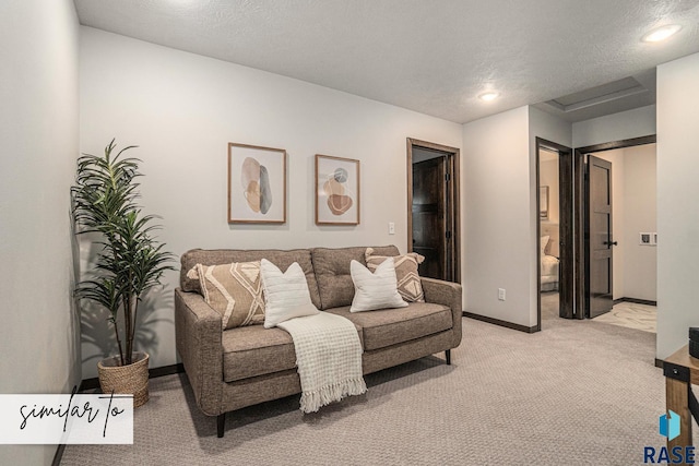 living room featuring light carpet and a textured ceiling