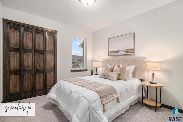 bedroom with light carpet and a textured ceiling