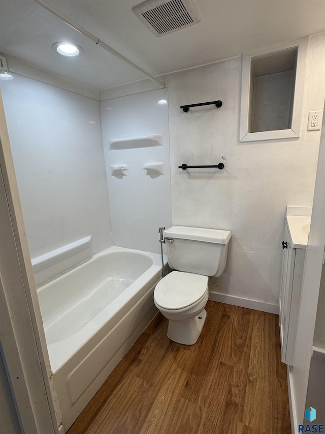 full bathroom featuring wood-type flooring, shower / bathing tub combination, vanity, and toilet