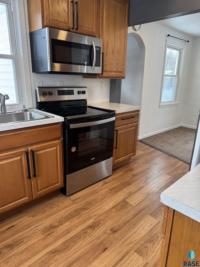 kitchen featuring sink, light hardwood / wood-style flooring, and appliances with stainless steel finishes