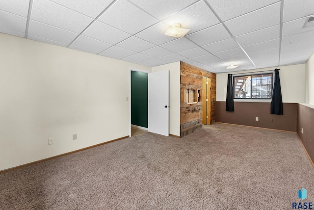 basement featuring carpet flooring and a drop ceiling