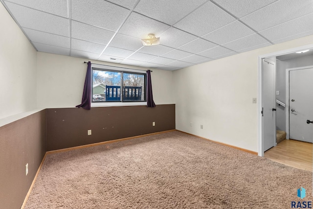 spare room with carpet flooring and a drop ceiling