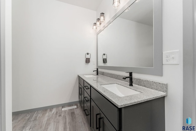 bathroom with vanity and hardwood / wood-style flooring