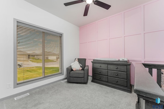 sitting room featuring light colored carpet and ceiling fan