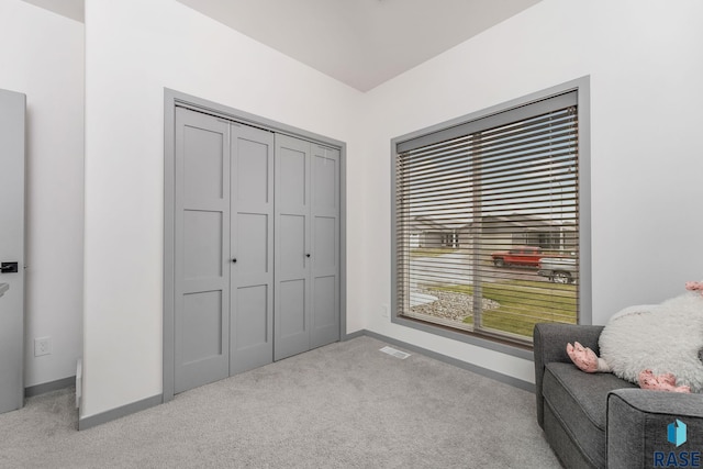 living area with light colored carpet