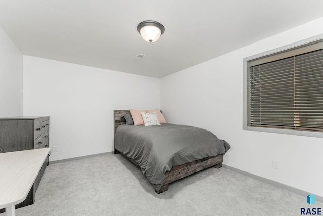 bedroom featuring light colored carpet