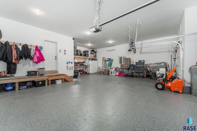 garage with a garage door opener and a wall mounted air conditioner