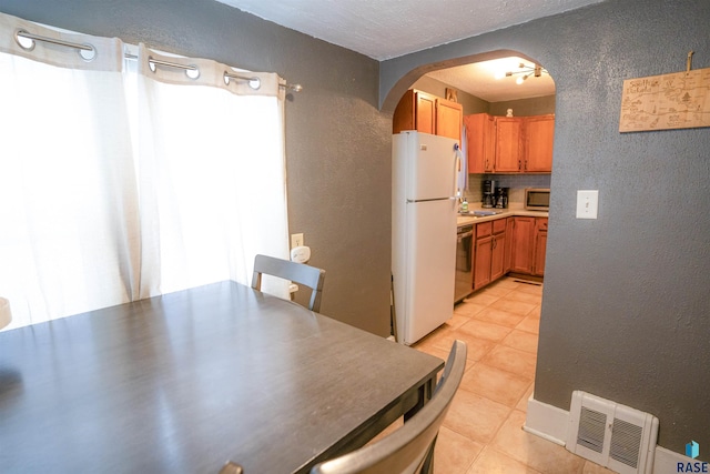 dining room featuring light tile patterned flooring and sink