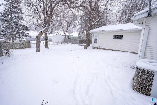 yard layered in snow featuring cooling unit