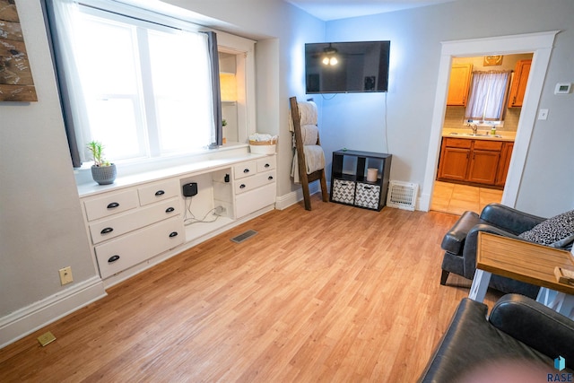 living room with sink and light hardwood / wood-style floors