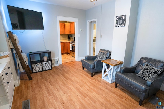 sitting room with light hardwood / wood-style flooring