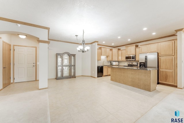 kitchen with a center island, stainless steel appliances, light brown cabinets, a sink, and baseboards