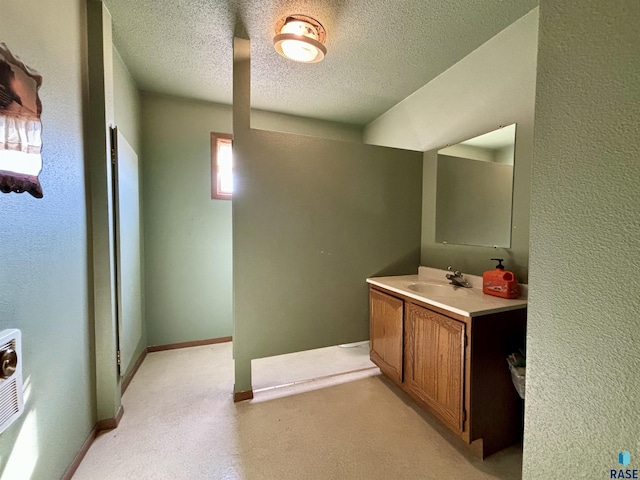 bathroom with vanity and a textured ceiling