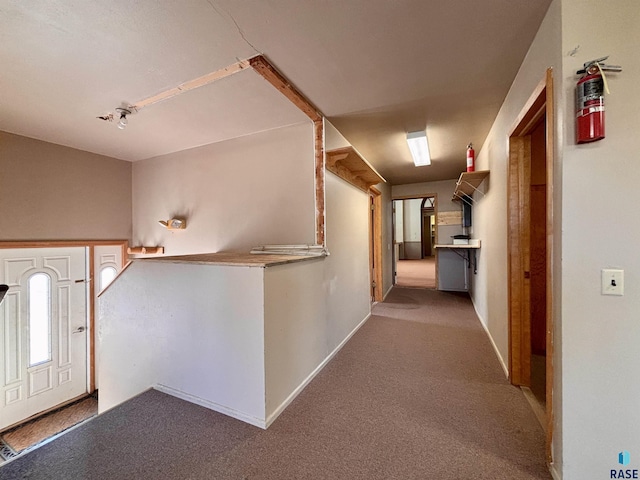 foyer featuring light carpet