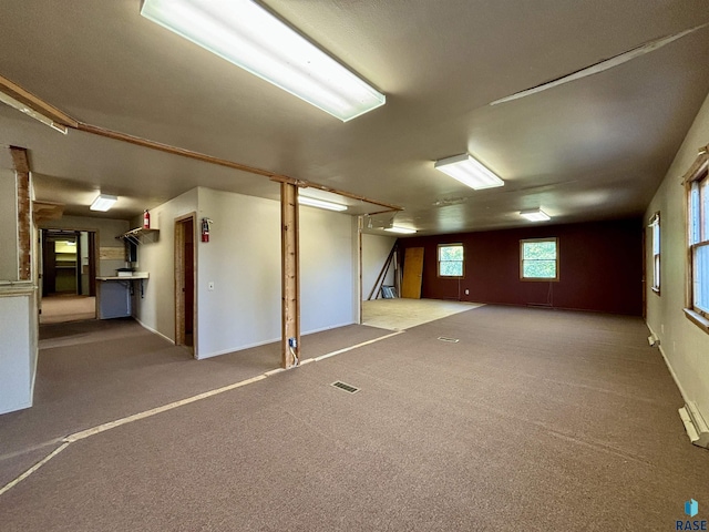 basement featuring light colored carpet