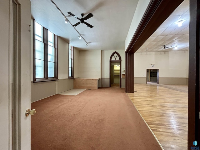 carpeted spare room featuring ceiling fan and rail lighting