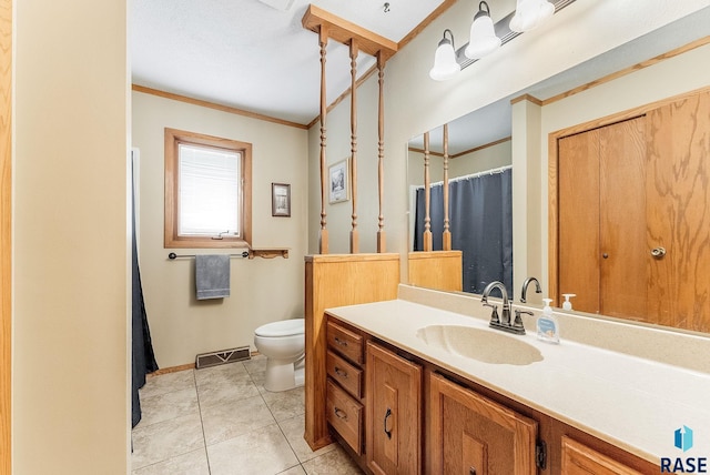 bathroom with crown molding, vanity, toilet, and tile patterned flooring