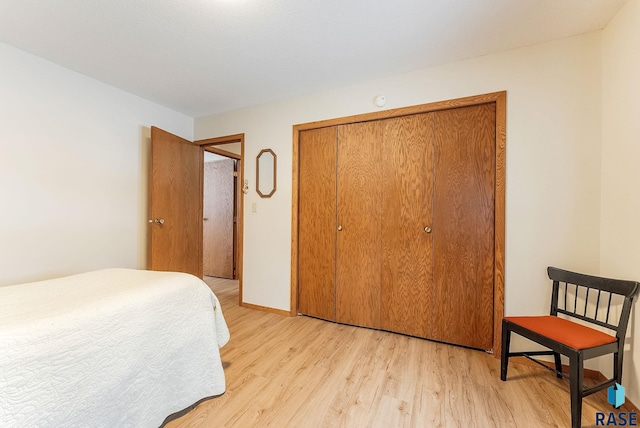 bedroom with a closet and light wood-type flooring