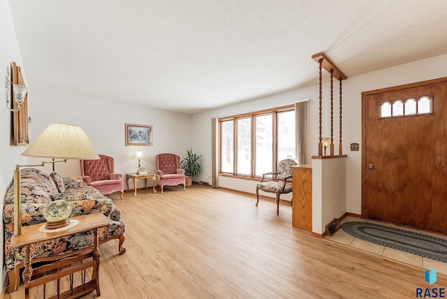 entrance foyer featuring a textured ceiling and light hardwood / wood-style floors