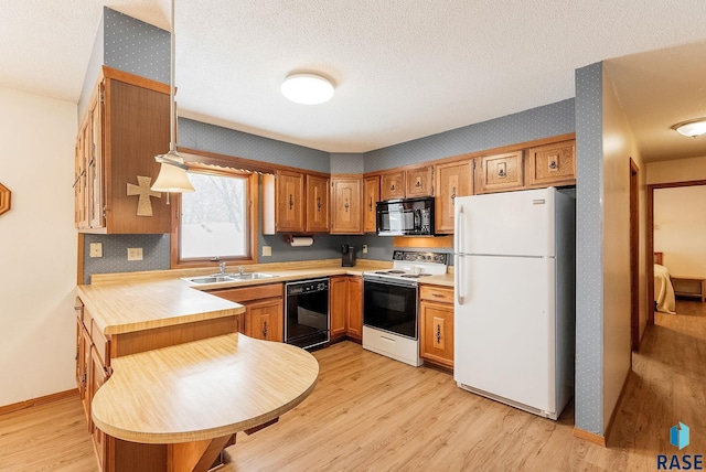 kitchen with sink, a textured ceiling, light wood-type flooring, and black appliances