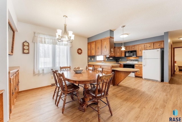 dining area featuring an inviting chandelier and light wood-type flooring