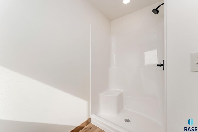 bathroom featuring wood-type flooring and walk in shower