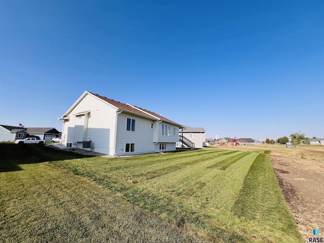 view of side of home featuring a lawn