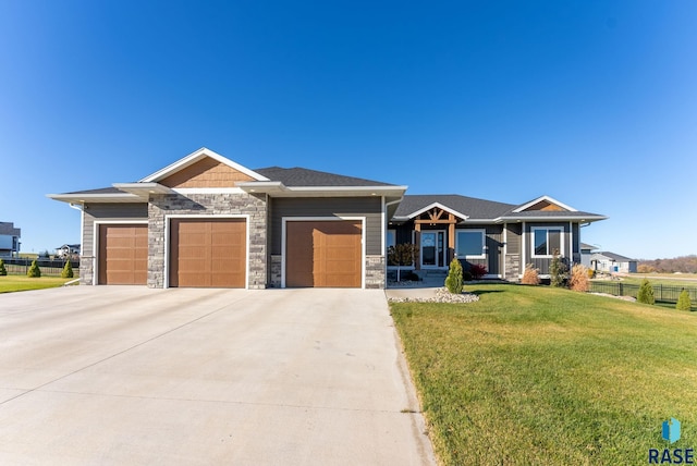 view of front of property featuring a garage and a front lawn