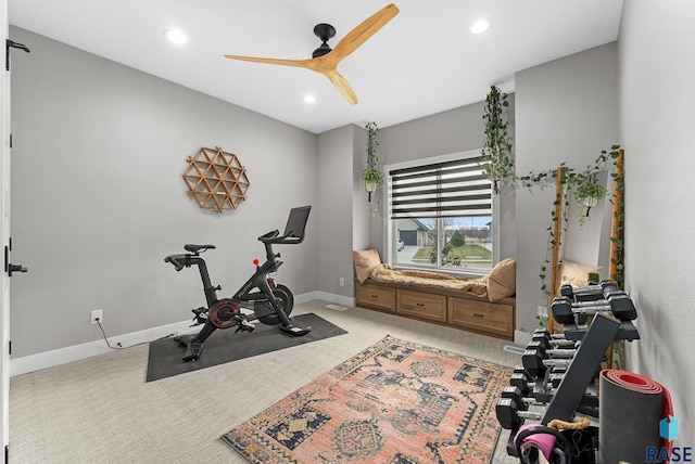 exercise room with ceiling fan and light colored carpet