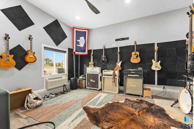 misc room featuring ceiling fan, hardwood / wood-style flooring, and a wall mounted AC