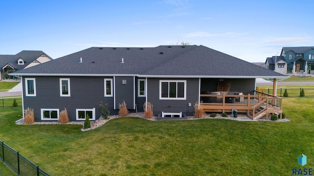 back of house featuring a wooden deck and a yard