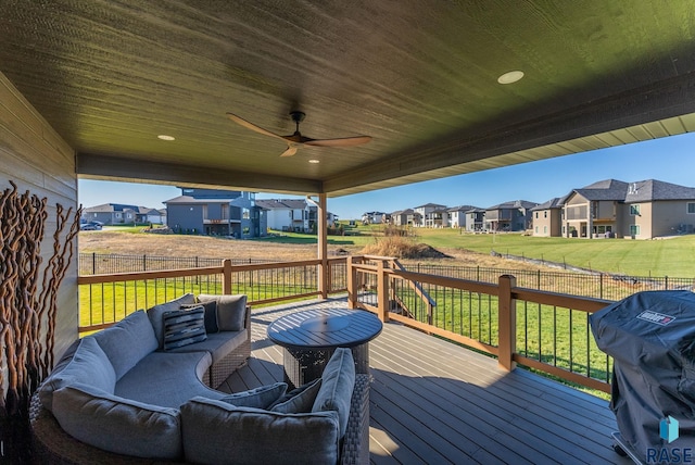 deck with area for grilling, an outdoor hangout area, a lawn, and ceiling fan