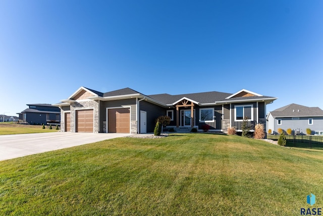 ranch-style home featuring a garage, covered porch, and a front lawn