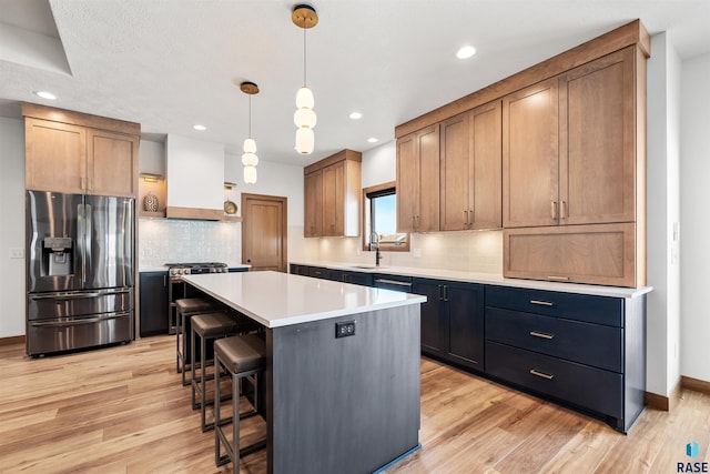 kitchen featuring pendant lighting, a center island, stainless steel fridge with ice dispenser, custom range hood, and light wood-type flooring