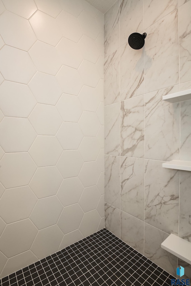 bathroom with tiled shower