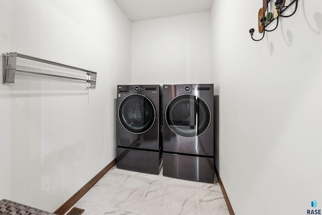 laundry area with washing machine and clothes dryer