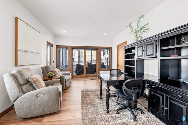 office with french doors and light hardwood / wood-style floors