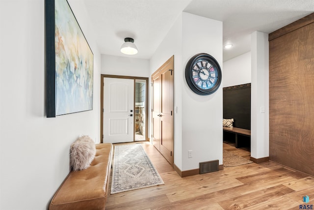 foyer entrance with light wood-type flooring