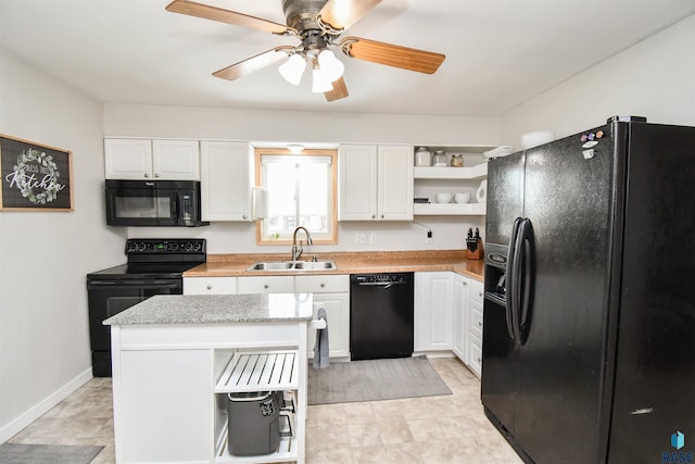 kitchen featuring white cabinets, light countertops, black appliances, open shelves, and a sink