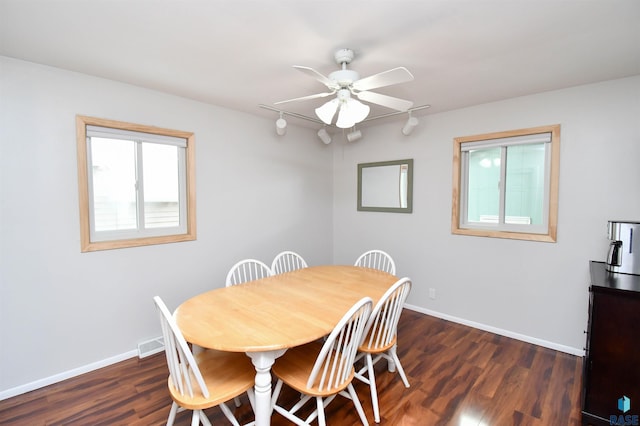 dining room with a ceiling fan, dark wood-style flooring, and baseboards