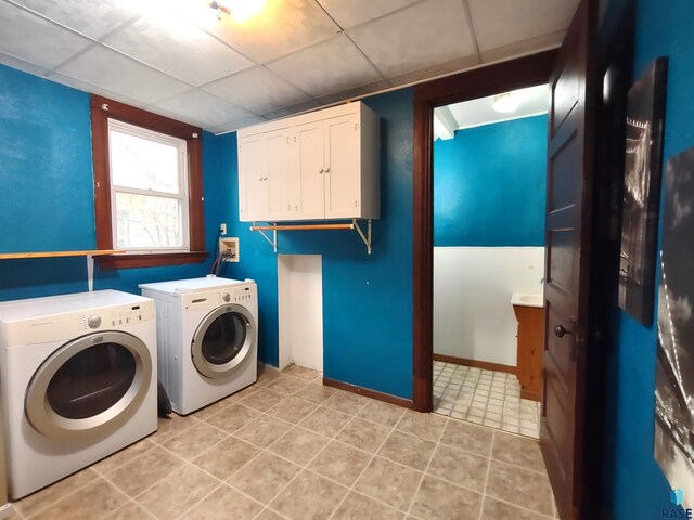 washroom featuring light tile patterned flooring, cabinets, and separate washer and dryer